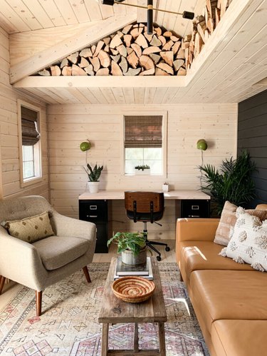 Rustic office with logs tucked into ceiling and wood plank walls