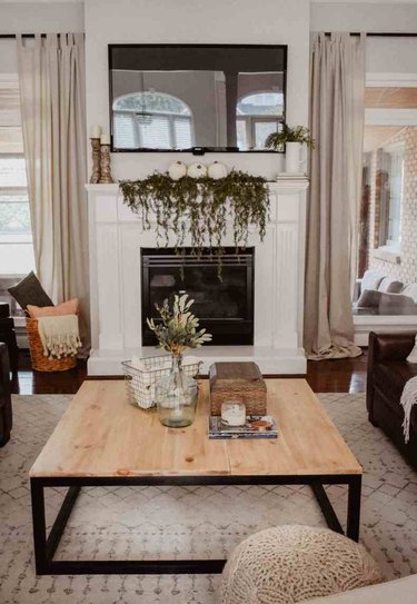 DIY rustic coffee table with black industrial legs in farmhouse living room