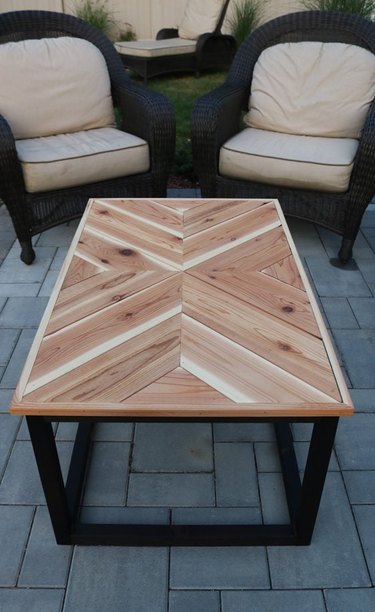 DIY rustic coffee table with wood chevron tabletop on patio