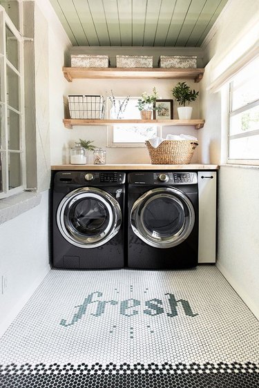 laundry room with washer and dryer with window plant shelves