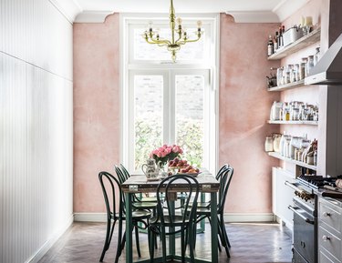 pink dining room in country kitchen with green chairs and table