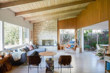 midcentury living room with wood paneling and light wood flooring