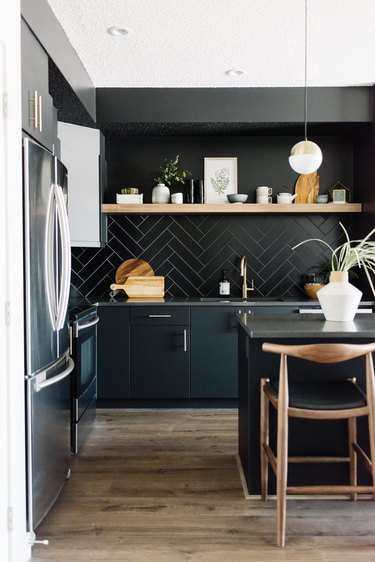 Modern kitchen idea with black herringbone backsplash