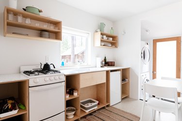 kitchen with open cabinets with kitchenware atop them