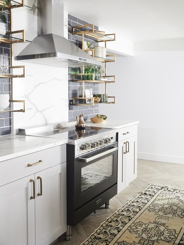 modern kitchen idea with marble backsplash and black accents