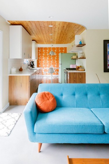 midcentury  living room with blue couch