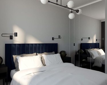 modern IKEA bedroom idea with articulating wall sconces and channel-tufted headboard