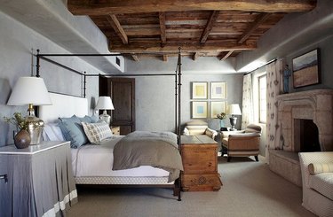 gray paint colors in bedroom with exposed wood ceiling beams and canopy bed