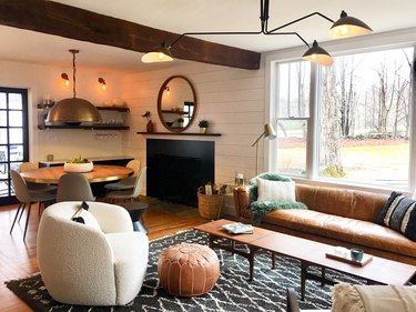 Living room in wintery setting with faux fur green throw, boucle side chair, and Moroccan shag carpet