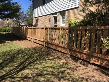 Wooden fence next to house.