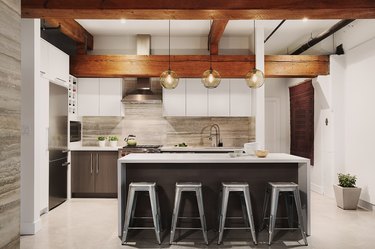 kitchen with glass pendants and exposed beams