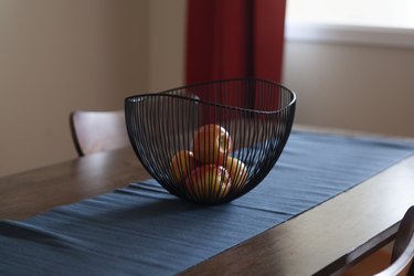 Bowl on dining table with fruit