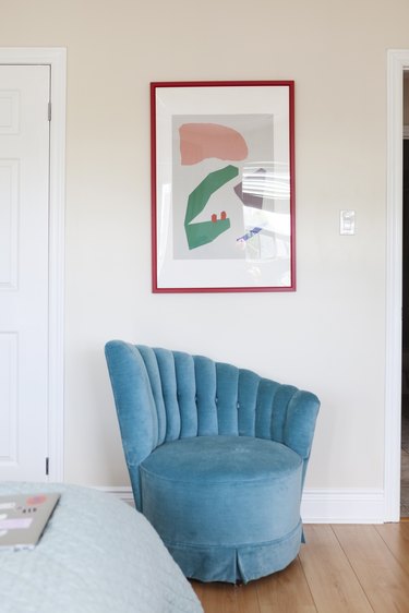 Blue velvet chair and artwork