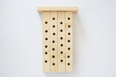 Bee house with wooden roof attached