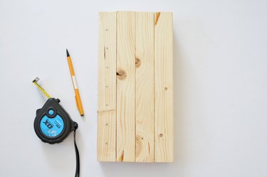 Measuring drill holes on bee house