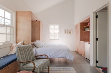 Murphy bed, built-ins, and entrance into the bathroom