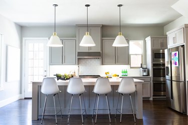 Tonal gray kitchen colors with white Eames style bar stools