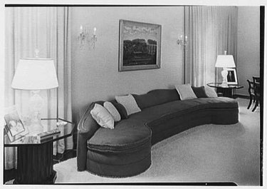 1930s living room with curved sectional sofa
