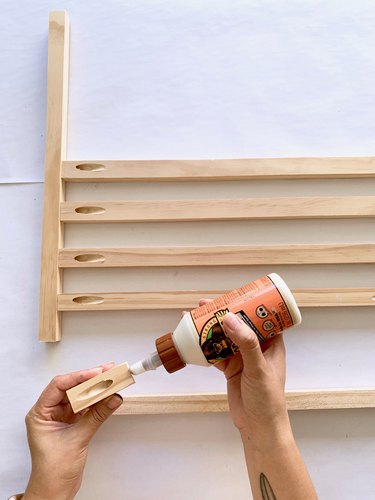 Wood dowels and glue for modern towel rack DIY