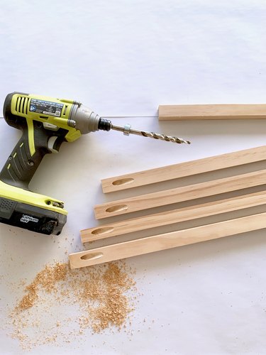 Drill and wood dowels for towel rack DIY