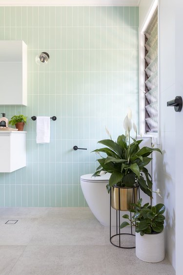 bathroom idea with mint green subway tile for minimalist decorating on a budget