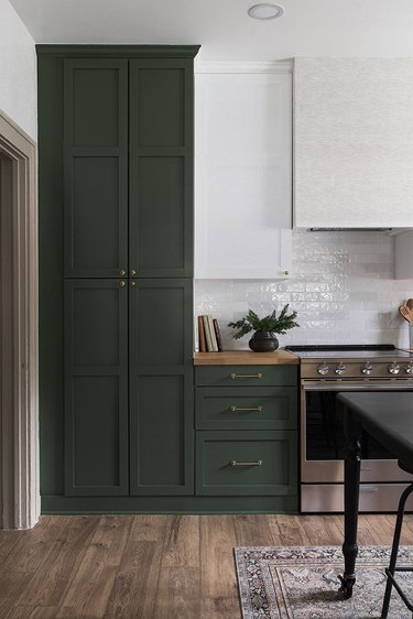 forest green kitchen cabinets with stainless steel stove