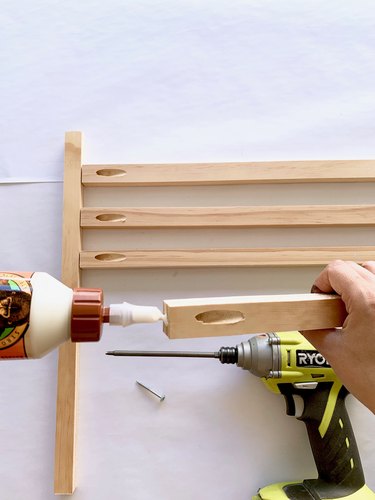 Wood glue, drill, and wood dowels for modern towel rack DIY