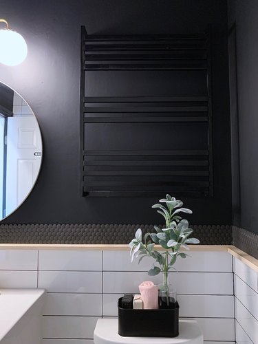 Black modern towel rack in black and white bathroom