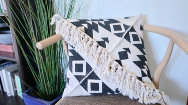 DIY Fringe Pillow Out of a Rug on wishbone chair.