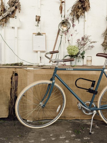 Vintage bike and flowers hung on a wall