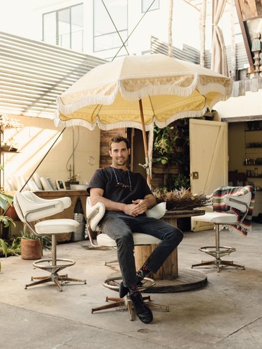 Spencer Falls relaxes on the patio at his studio