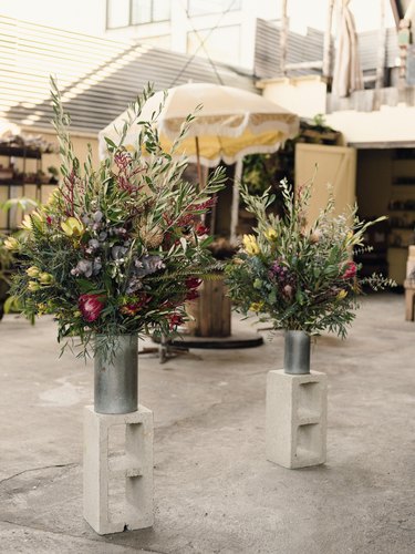 Bouquets of flowers set on cinder blocks