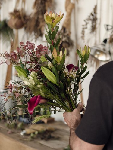 Florist Spencer Falls with a bouquet of flowers