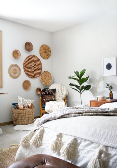 Bedroom wall decor idea with baskets on bedroom wall
