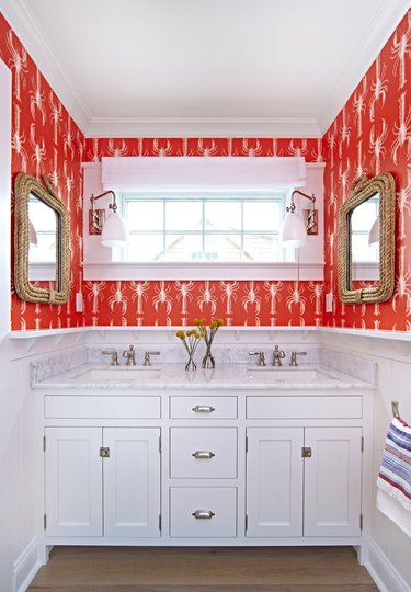 colors that go with red in a red and white bathroom with lobster print wallpaper