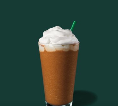 frappucino in a glass with green straw