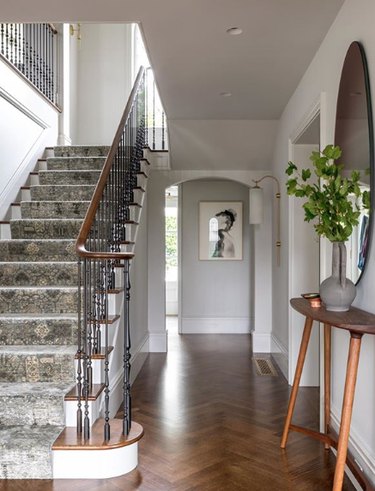 hand-carved railing on traditional staircase with runner