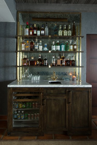 glam rustic bar ideas with gold shelves and marble counter