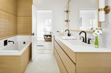 bathroom backsplash idea in marble with wood vanity cabinet