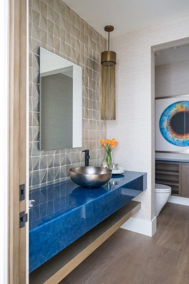 bathroom backsplash idea with geometric tile and blue floating vanity