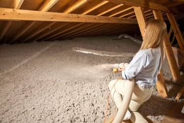 Blowing insulation in the attic.