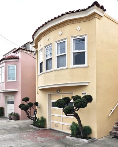 Yellow traditional stucco homes in row of townhouses