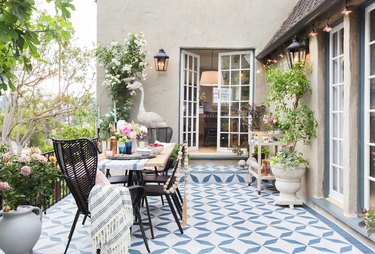 beige traditional stucco homes and back patio with blue floor tile