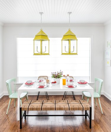 chartreuse color idea in white dining room with chartreuse pendants over table