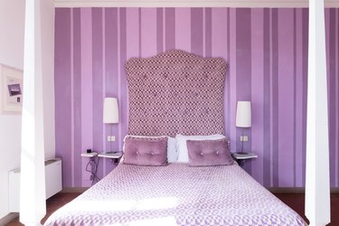 purple striped bedroom with large bed and cool colors