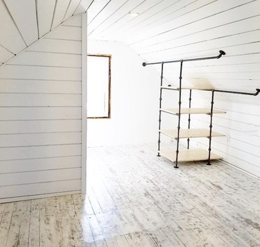Custom industrial closet ideas in white shiplap attic