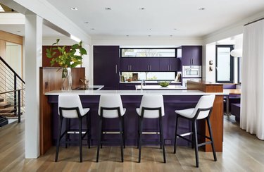 kitchen with white chairs and eggplant cool colors on the cabinets
