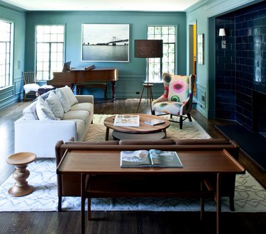 living room with couch, piano, and teal cool colors