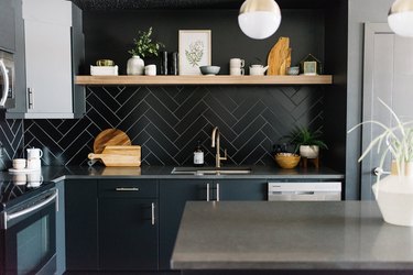 black kitchen backsplash with black cabinetry and open shelving