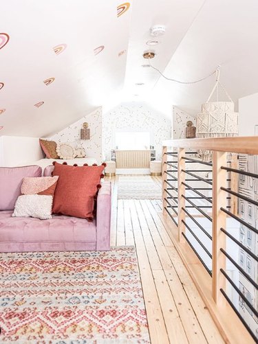 boho attic living room with wood floors, rugs and woven accessories